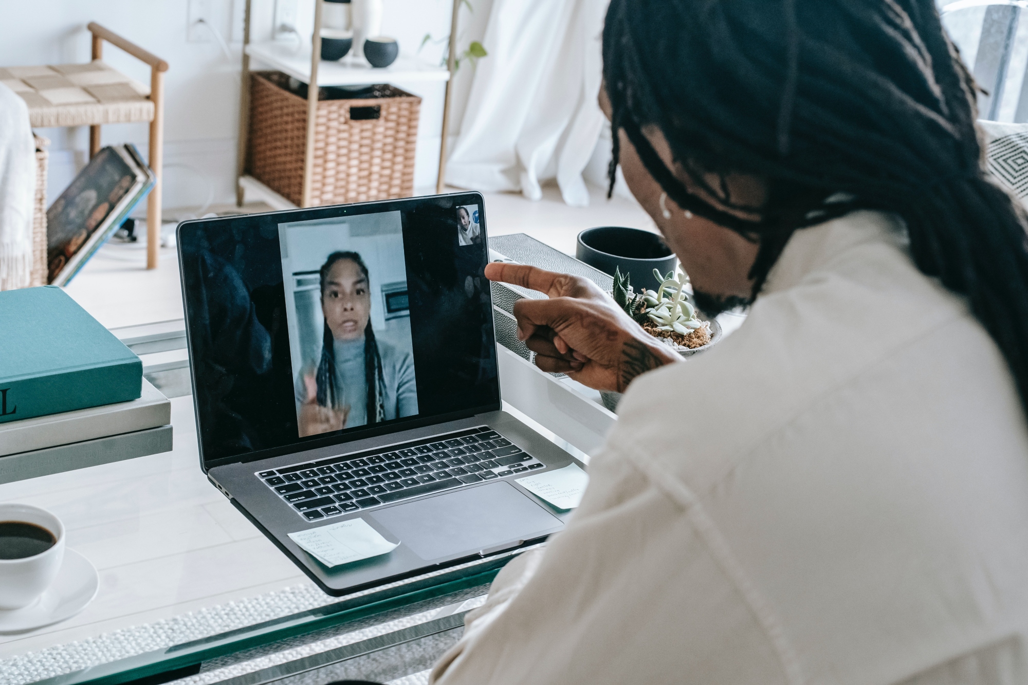 A woman on a laptop talks to another woman via videocall