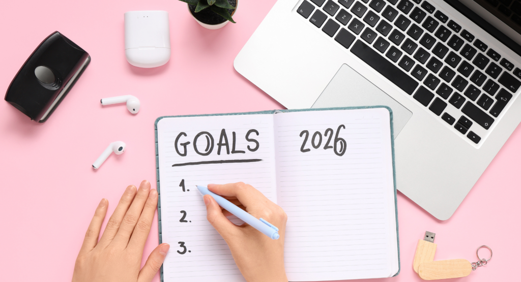 marketing in 2026 - a hand is wiring in a diary with a laptop open