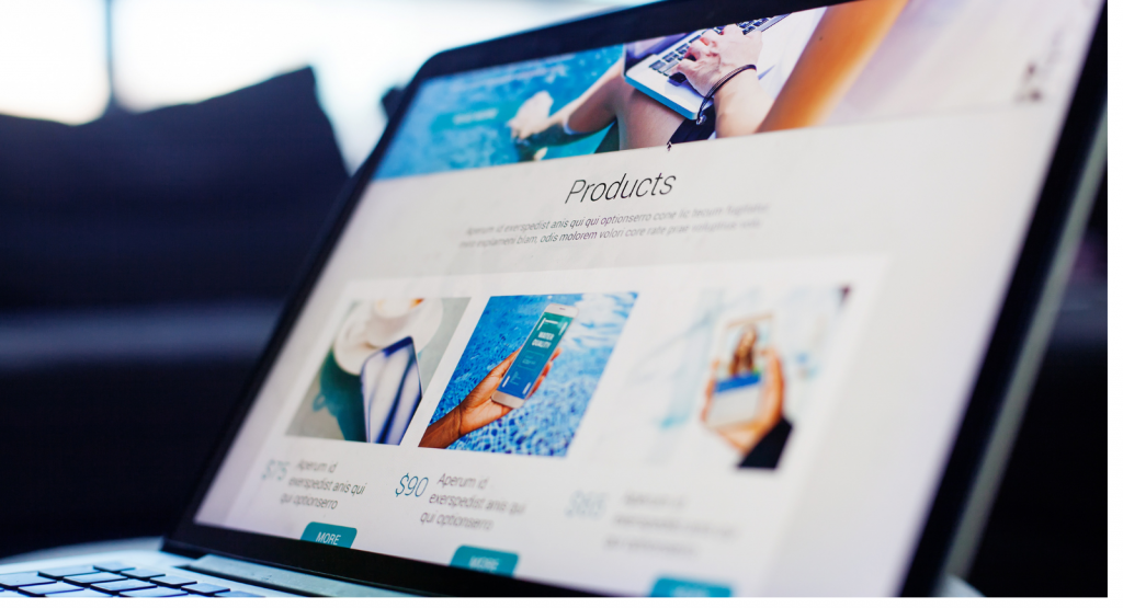 A laptop shows a website with a list of products